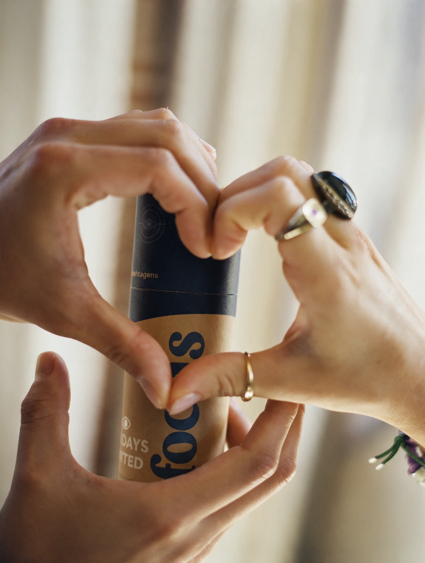 Two hands making a heart around a Focus tube